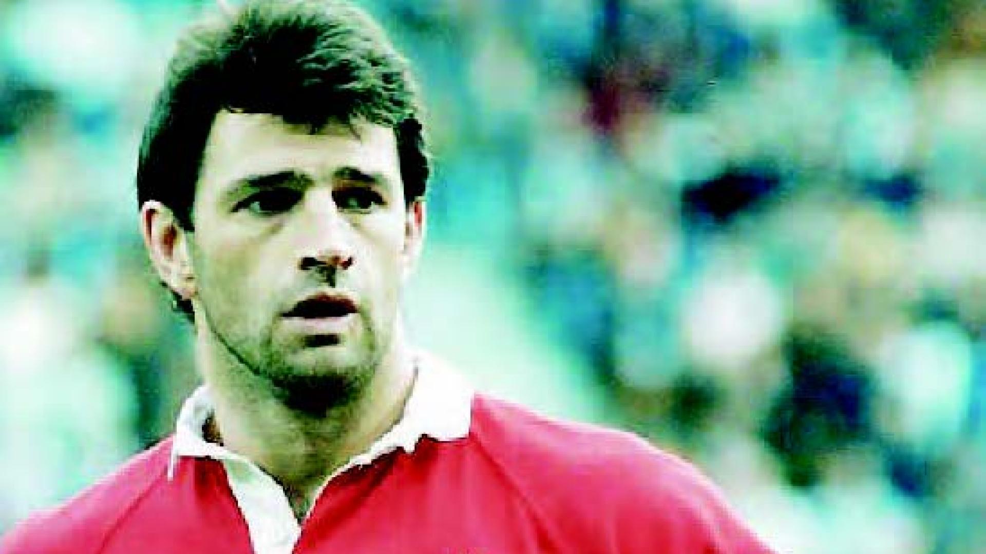 Rob VanderBrink stands in a red polo shirt with a white maple leaf on the chest.